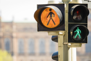 Image is of a pedestrian crossing traffic light, concept of pedestrian accidents and legal rights.