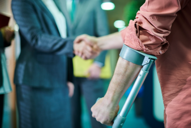 Image is of an injured man shaking hands with his lawyers, concept of what to expect during a personal injury lawsuit