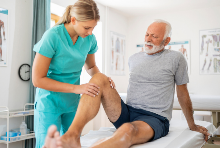 Image is of a man having a knee injury examined by physician, concept of when to hire a personal injury lawyer