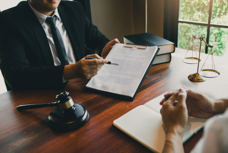 Image is of a criminal defense lawyer explaining charges to client, concept of understanding domestic violence charges in South Carolina