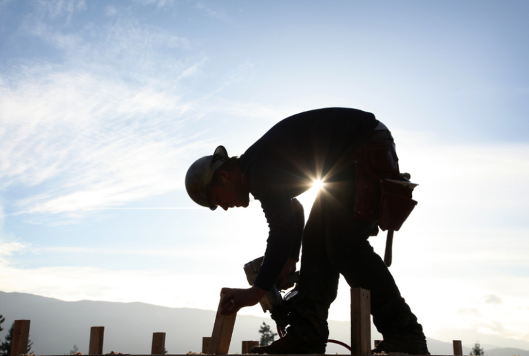 Image is a silhouette of a construction worker, concept of workers' compensation laws in South Carolina