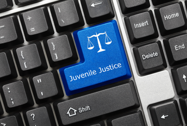 Image is of a closeup of a keyboard and the enter button reads' juvenile justice', concept of what is the age of criminal responsibility in South Carolina