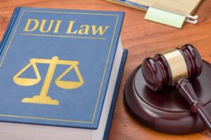 Image is a DUI Law book and gavel, concept of reinstating your license after a DUI in Aiken