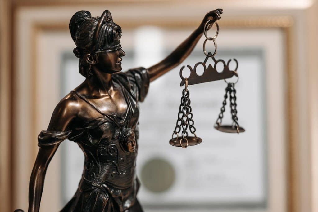 Lady Justice statue holding balanced scales.