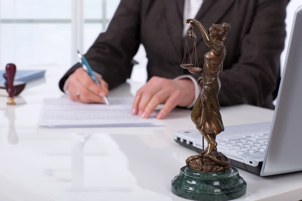 Lady Justice statue placed on lawyer’s desk.