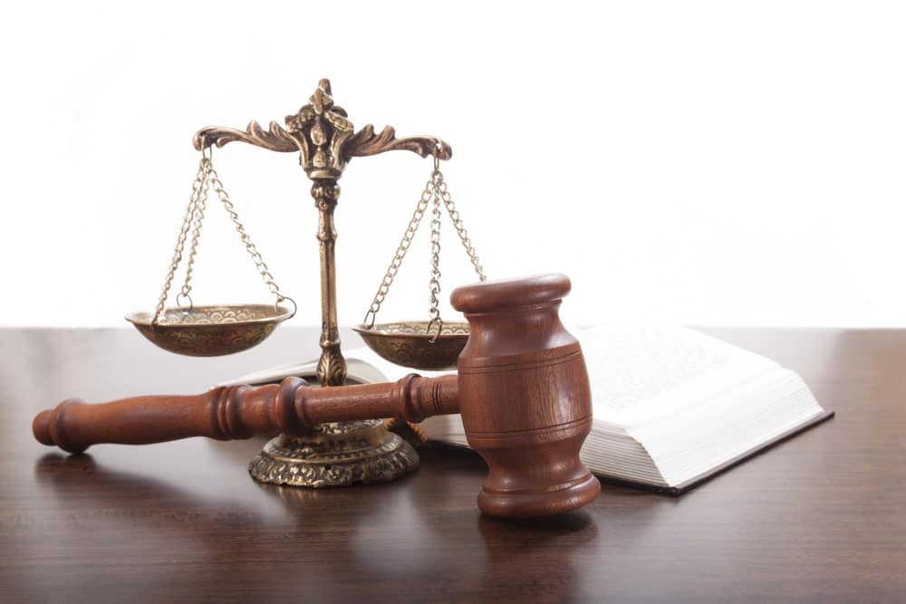 Image shows a gavel and scales of justice on a desk, representing legal help for medical bills after a car crash in SC.