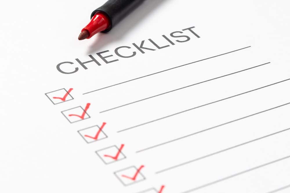 Image is of a checklist with red checkmarks marked complete, concept of steps required to file a car crash claim within legal deadlines.
