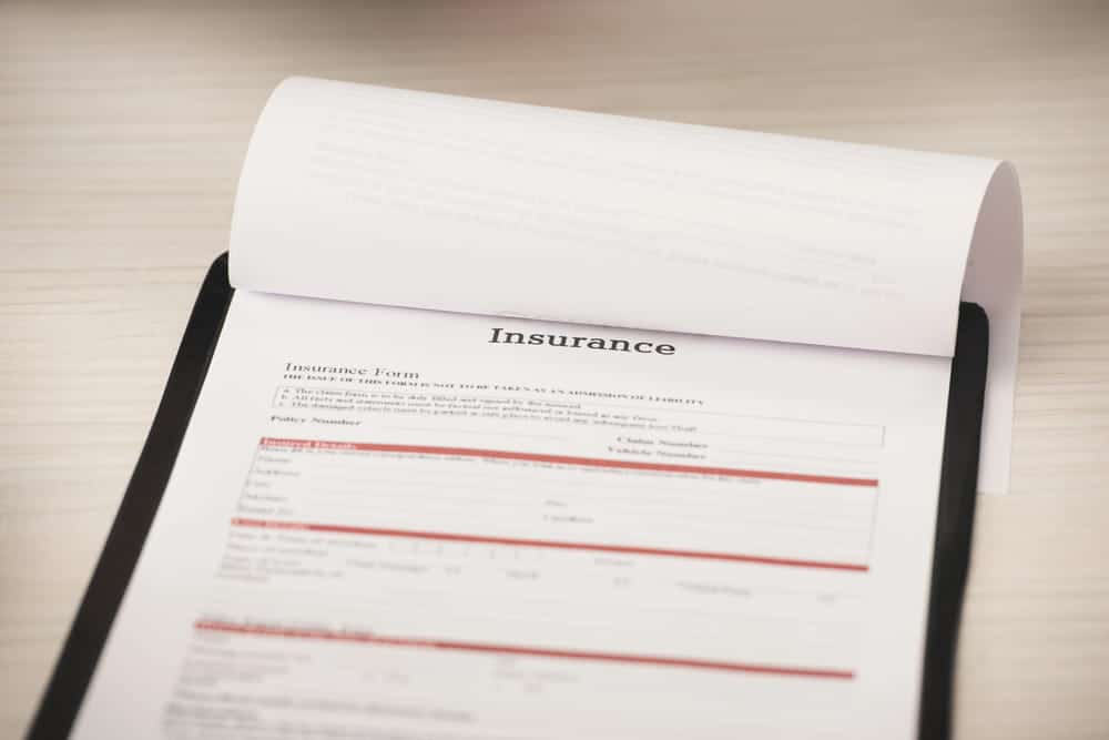 Image is of an insurance form on a desk, concept of filing a bicycle accident claim after an injury in South Carolina.
