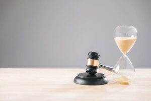 Image is of a gavel placed beside an hourglass, symbolizing how time passes during a DUI case and how long the legal process may take
