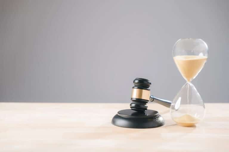 Image is of a gavel placed beside an hourglass, symbolizing how time passes during a DUI case and how long the legal process may take