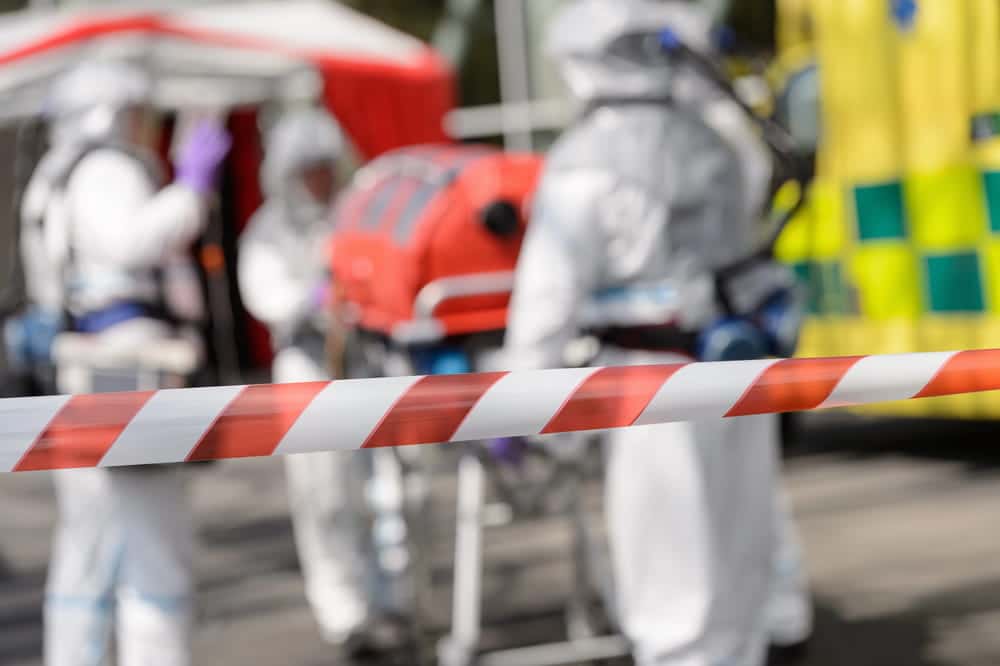 Image is of emergency responders in protective suits securing an accident scene, concept of truck accidents in Aiken involving hazardous exposure
