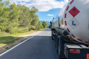 Image is of a fuel tanker truck carrying hazardous materials on a roadway, concept of truck accidents in Aiken involving dangerous cargo transport