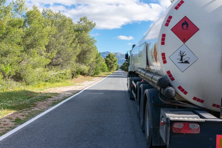 Image is of a fuel tanker truck carrying hazardous materials on a roadway, concept of truck accidents in Aiken involving dangerous cargo transport