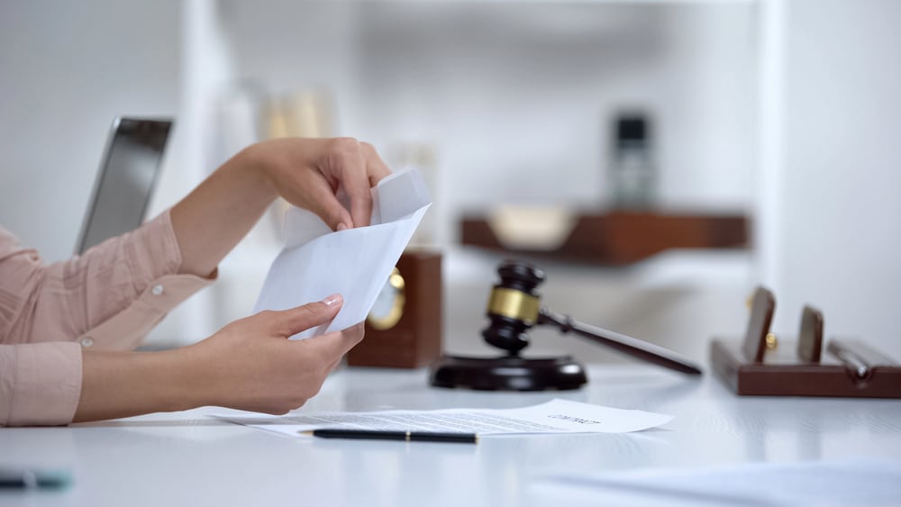 Image is of an individual organizing legal paperwork and financial records during a family law matter, concept of an alimony lawyer.