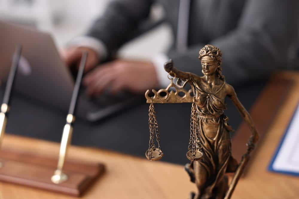 Image is of a Lady Justice statue in a law office representing legal advocacy and court proceedings, concept of an alimony lawyer.