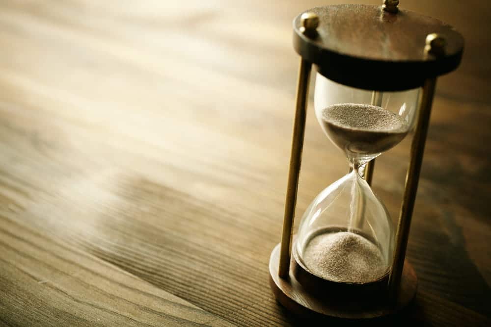 Image is of an hourglass measuring the passage of time, concept of payment duration and obligations discussed with a child support lawyer in Aiken.