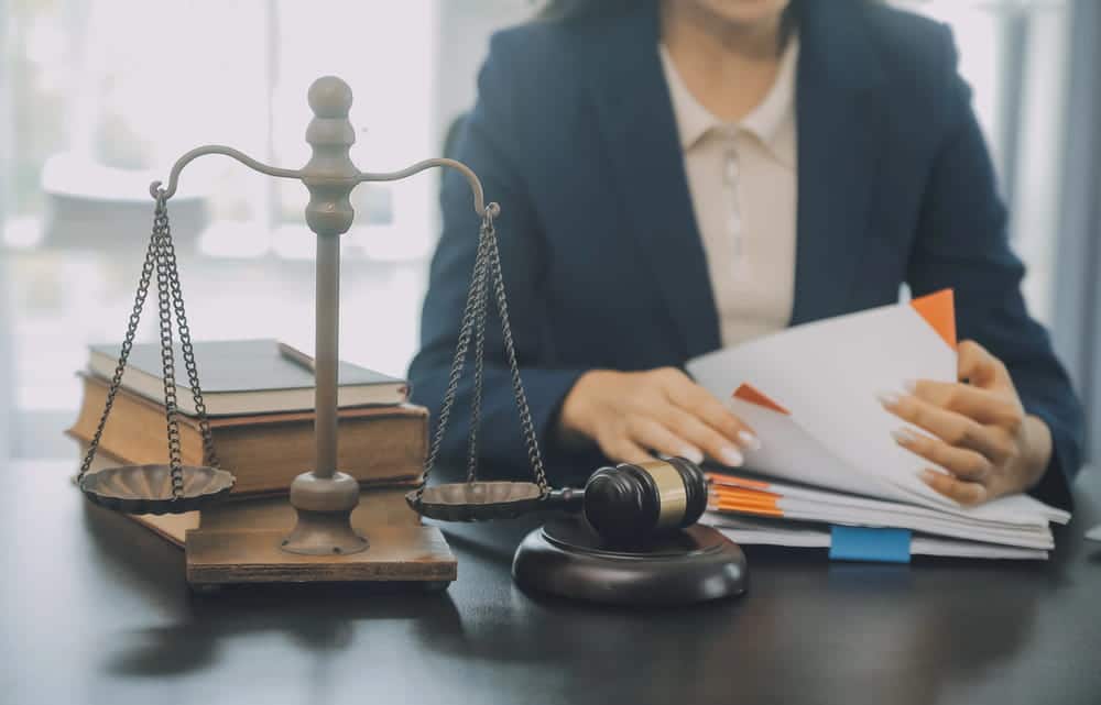 Image is of legal documents, a gavel, and scales of justice on a desk, concept of an Aiken custody modification lawyer preparing documentation for a custody modification case.