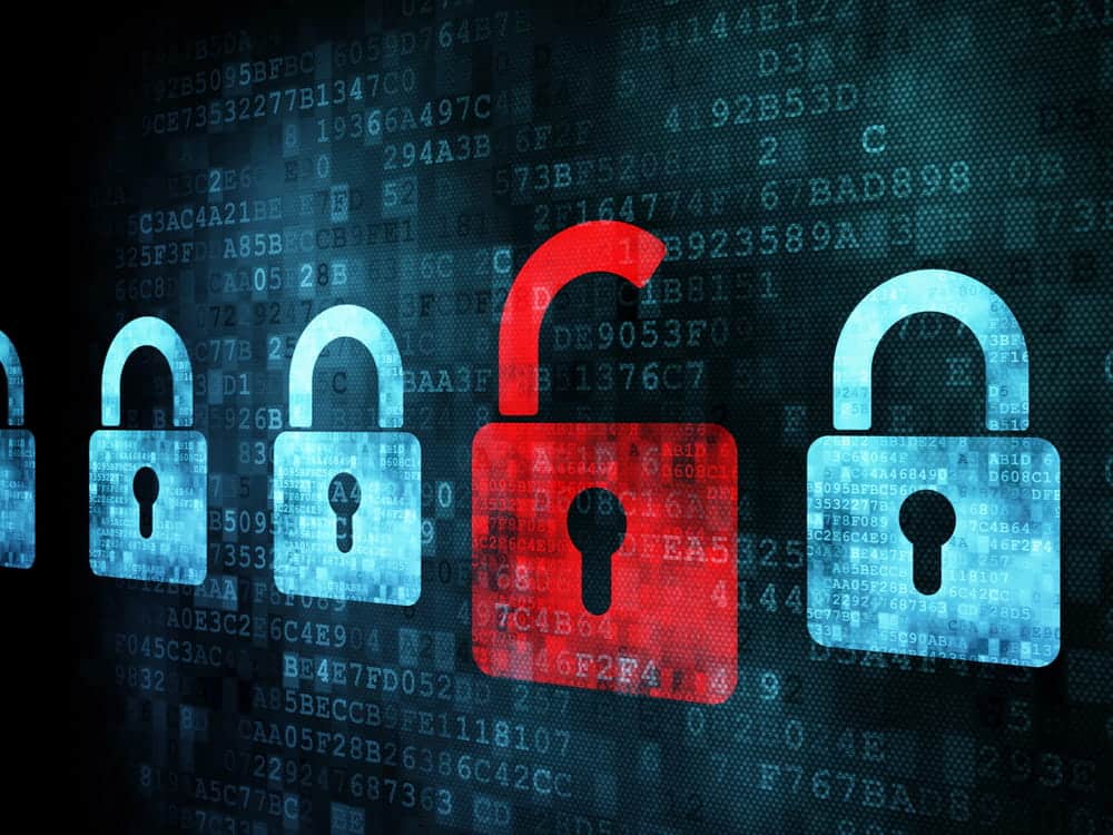 Image is of digital padlock icons displayed over computer code, concept of an Aiken cyber crimes lawyer defending cases involving data security and computer offenses.