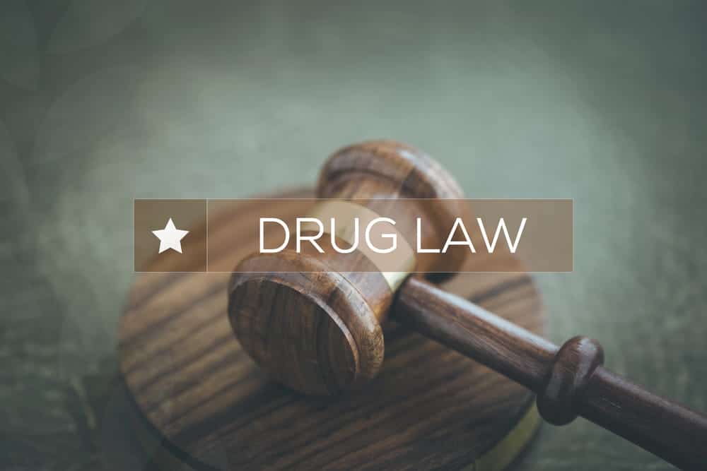 Image is of a courtroom gavel with a drug law theme, concept of an Aiken drug distribution lawyer addressing criminal charges and court proceedings involving controlled substances.
