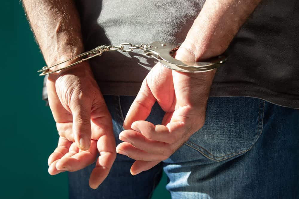 Image is of an individual wearing handcuffs after an arrest, concept of Aiken felony lawyer helping clients respond to felony criminal charges.