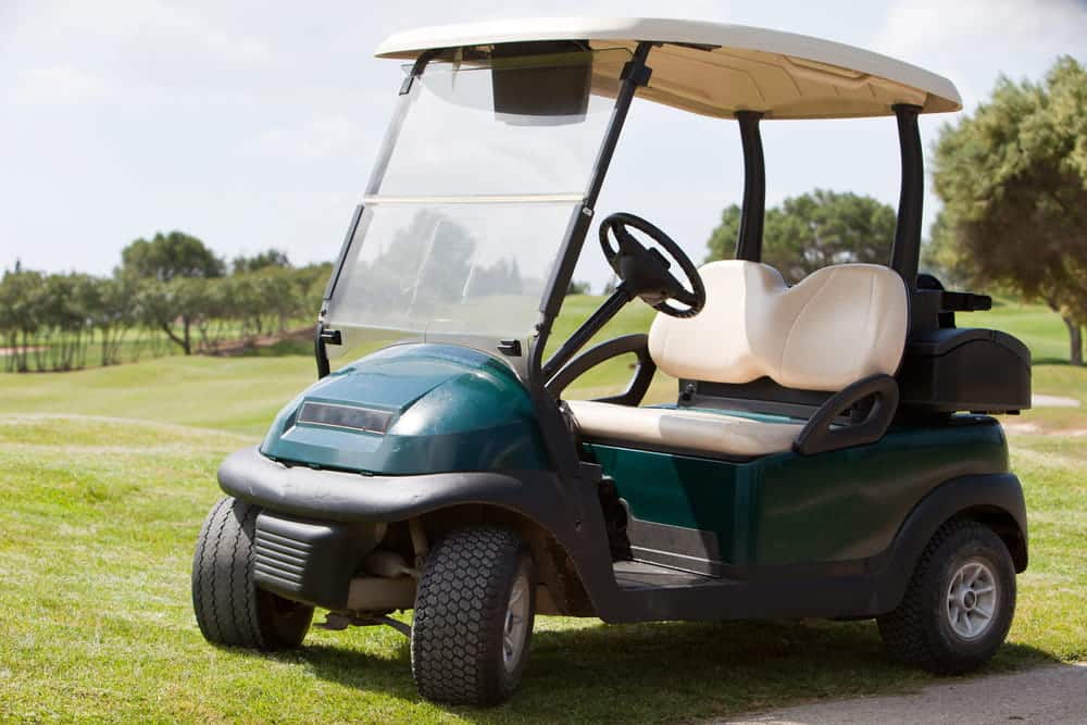 Image is of a golf cart parked on a golf course, concept of a golf cart accident lawyer helping injured victims pursue compensation after a collision.