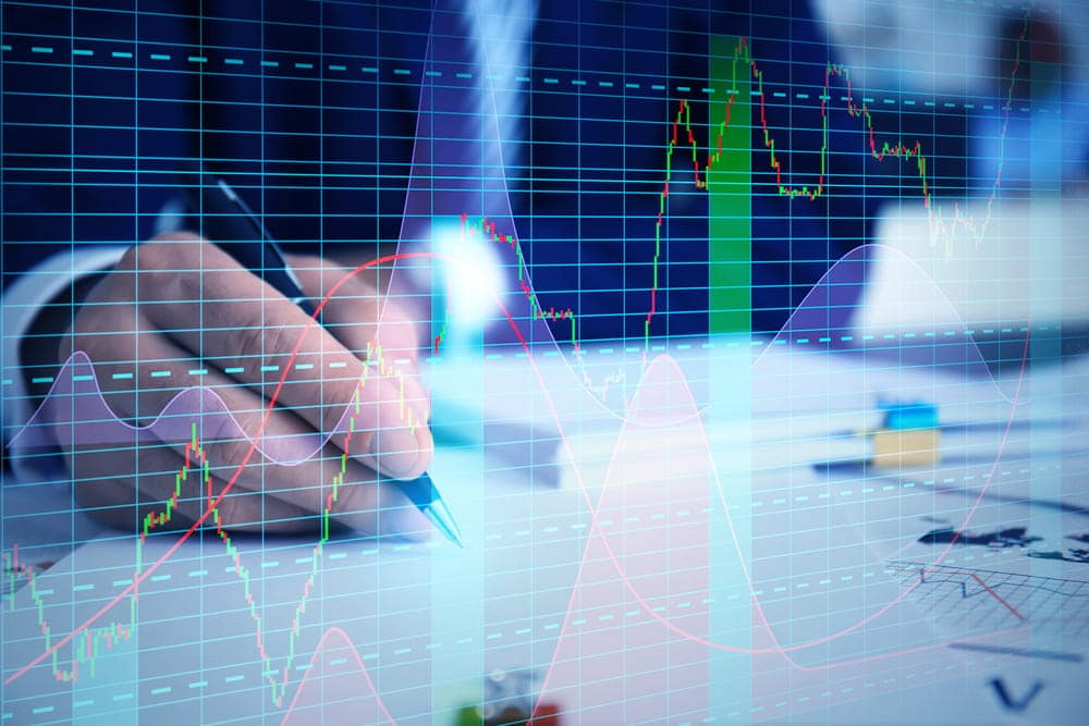 Image is of stock market charts and financial data showing investment activity, concept of an Aiken insider trading lawyer analyzing trading records and market evidence.