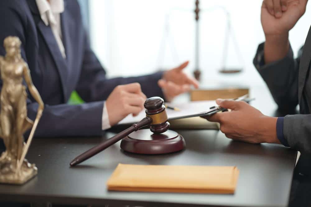 Image is of an attorney meeting with a client to discuss legal matters, concept of Aiken misdemeanor lawyer providing guidance during misdemeanor court proceedings.