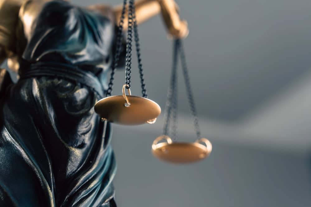 Image is of the scales of justice in close view, concept of an Aiken money laundering lawyer representing clients accused of financial crimes.