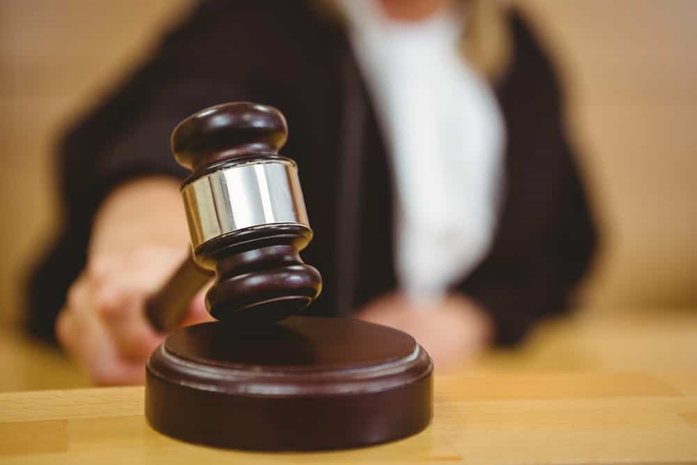 Image is of a judge's gavel being brought down in a courtroom setting, concept of an Aiken order of protection lawyer helping clients seek or respond to court-issued protective orders.