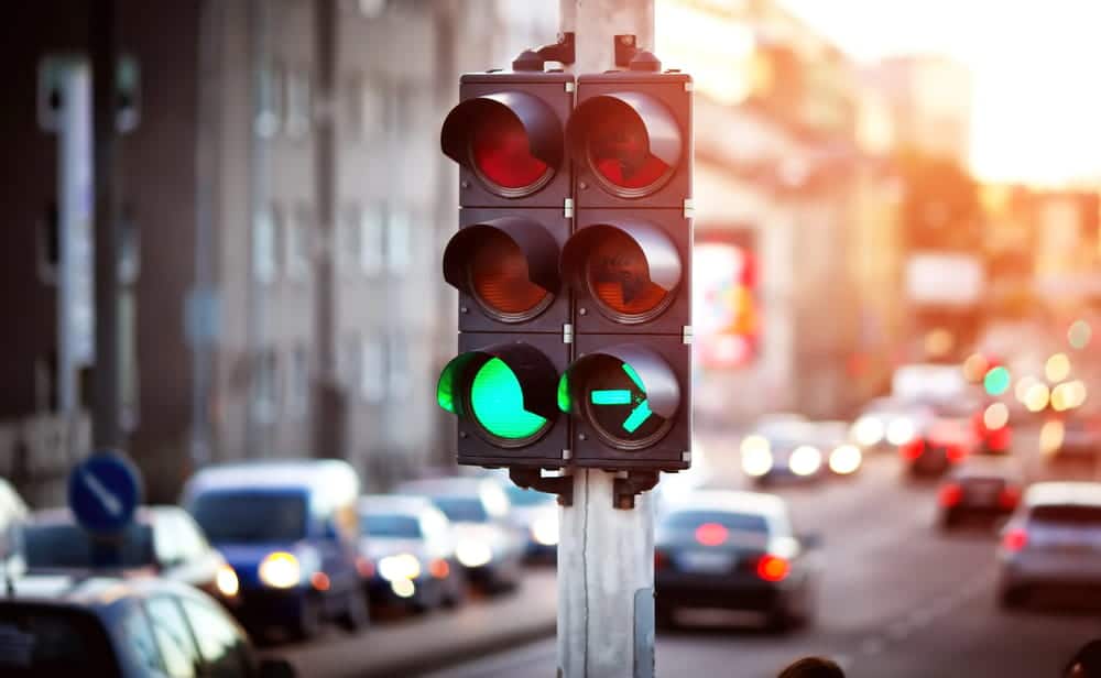 Image is of a traffic signal at a busy intersection, concept of an Aiken traffic violations lawyer reviewing roadway conditions and traffic control evidence in a citation case.