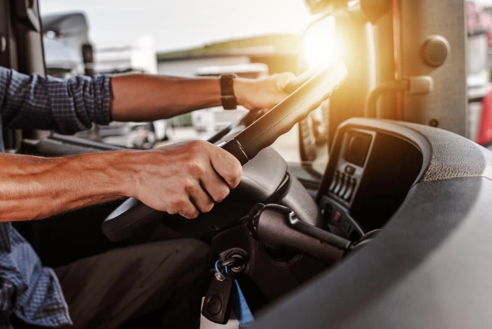 Image is of a commercial truck driver operating a vehicle, concept of an Aiken truck accident lawyer examining trucking industry safety issues.