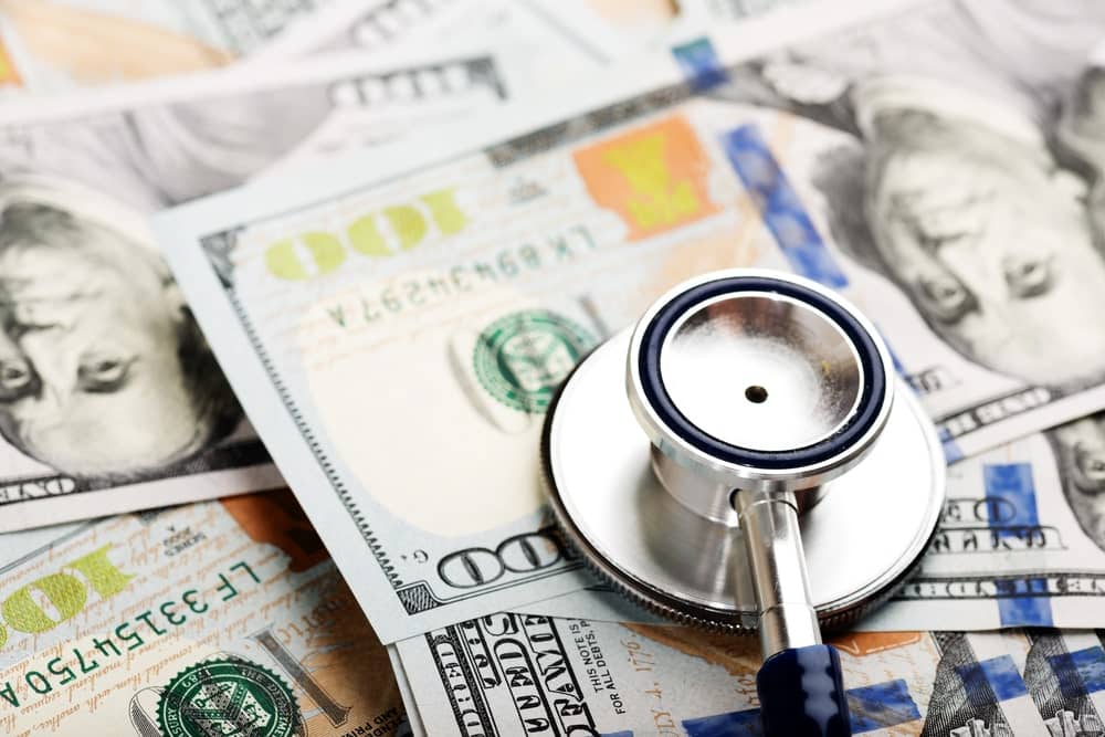 lt Text: Image is of a stethoscope placed on currency, concept of a workers' compensation lawyer pursuing benefits for lost wages and medical expenses.