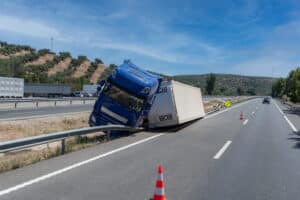 Image is of a commercial truck involved in a highway crash, concept of black box evidence supporting a truck accident claim after a serious collision.