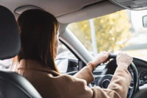 Image is of a driver operating a vehicle, concept of DUI suspension in Aiken and questions about whether driving privileges are still allowed.