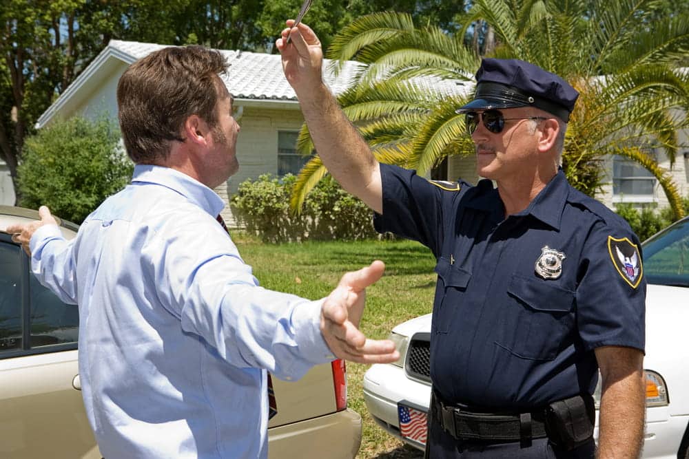 Image is of a police officer conducting a roadside field sobriety test during a traffic stop, concept of a DUI lawyer in Aiken assisting individuals facing DUI investigations.