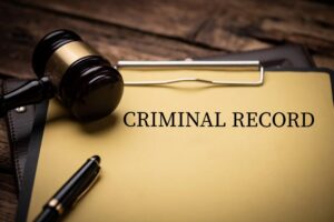 mage is of a criminal record file with a gavel and legal paperwork, concept of how a drug charge can affect a person's record and future opportunities.