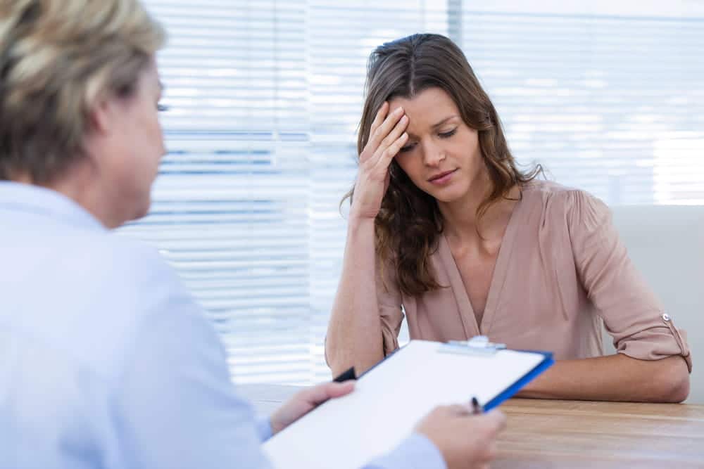 Image is of an individual discussing emotional and psychological challenges with a healthcare professional after a car crash in Aiken.