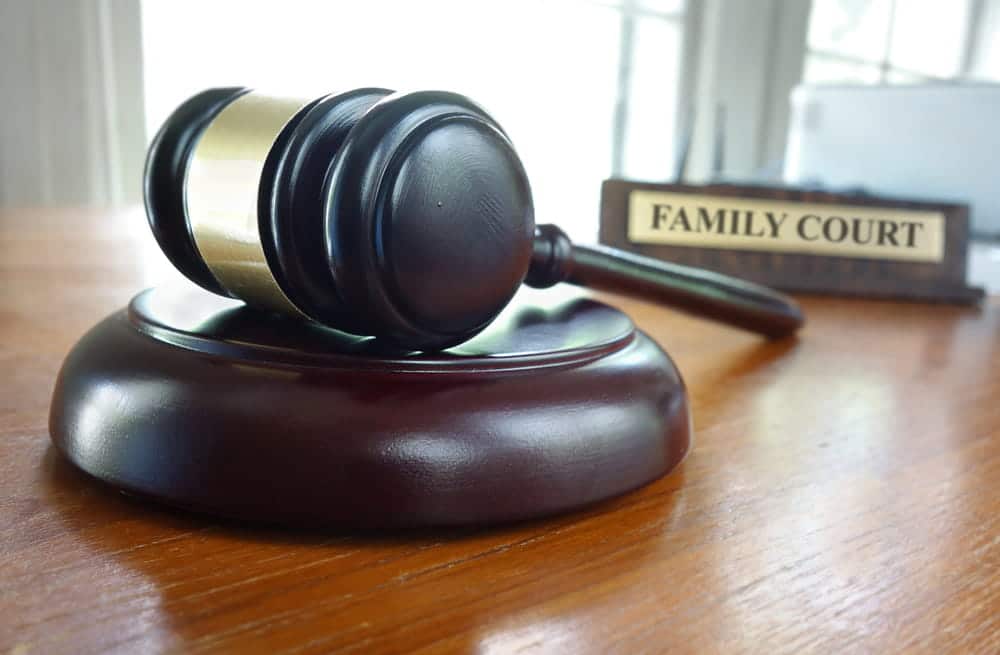 Image is of a judge's gavel in a family courtroom, representing the legal process for deciding child custody.
