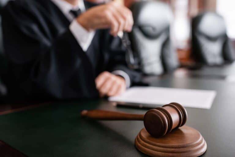 Image is of a judge reviewing a family law case before making a decision about child custody.