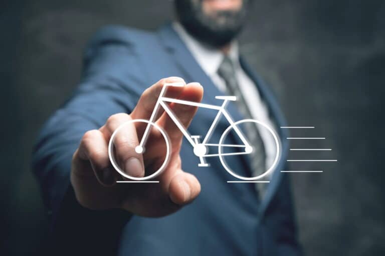 Image is of a person pointing toward a bicycle icon, concept of insurance coverage for bicycle accidents in Aiken.