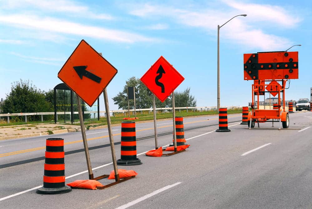 Image is of a roadway with construction signs, traffic barrels, and lane changes, concept of motorcycle accidents in Aiken caused by construction zones and changing road conditions.