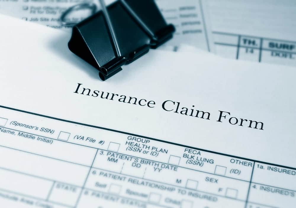 Image is of an insurance claim form with paperwork, concept of filing a claim after a truck accident in Aiken.