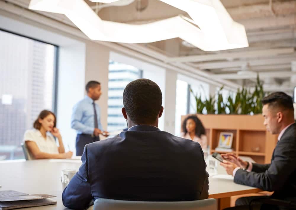 Image is of professionals discussing a workplace matter, concept of how a DV arrest can affect a professional license in Aiken