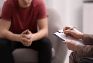 Image is of a person meeting with a counselor during a legal consultation, concept of DUI diversion in Aiken.
