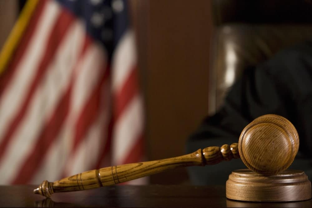 Image is of a judge’s gavel in a courtroom, representing how courts consider factors when deciding an alimony award.