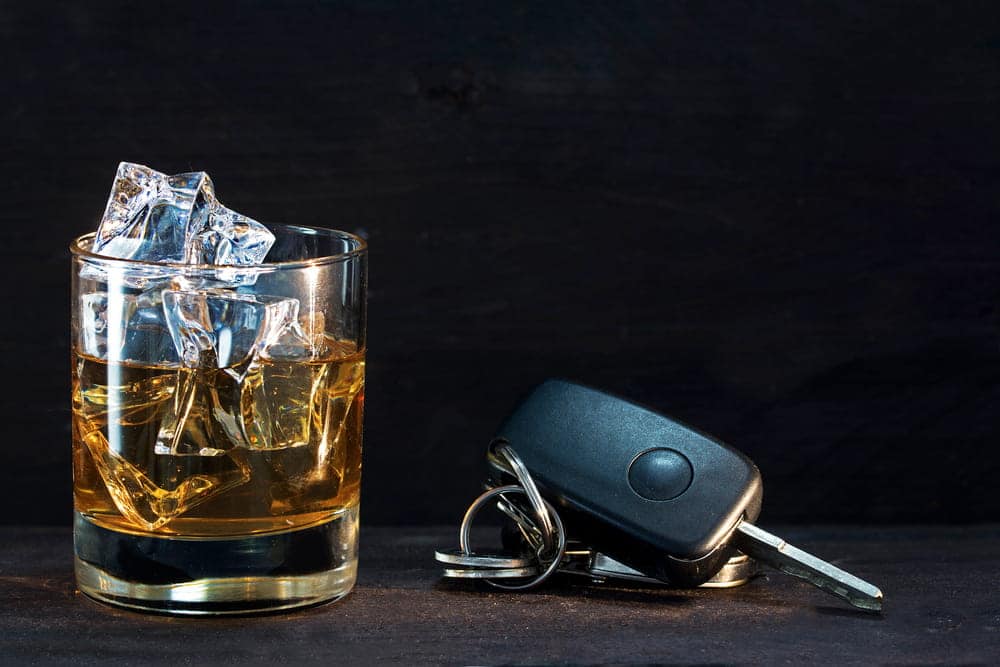 Image is of alcohol beside car keys, concept of how a DUI conviction can affect housing in Aiken.