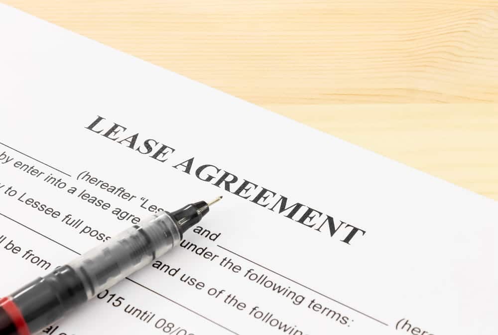 Image is of a lease agreement and pen, concept of how a DUI conviction may affect rental housing in Aiken.