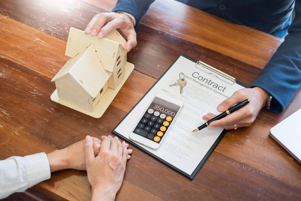 Image is of a renter reviewing a housing agreement, concept of how a DUI conviction may affect rental applications.